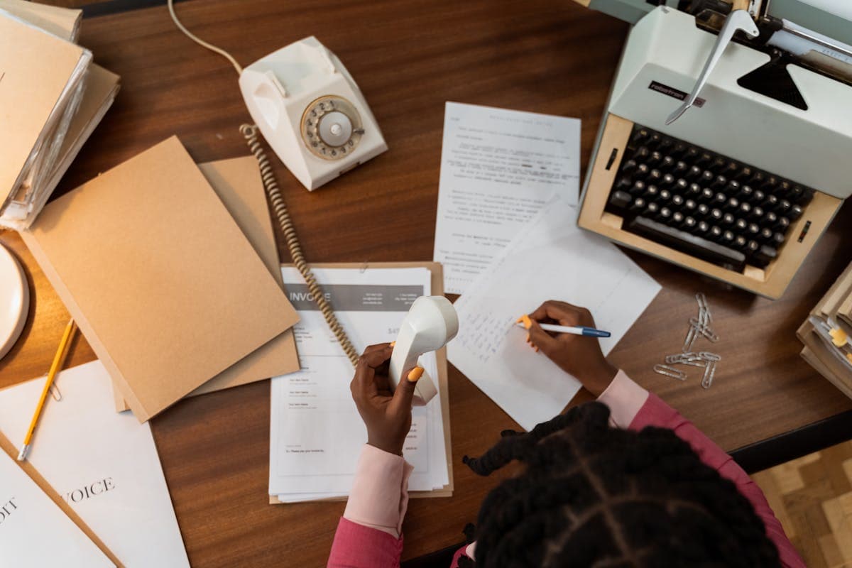 Desk overflowing with invoices and paperwork for payment processing