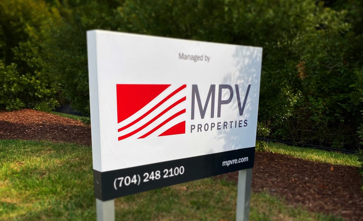 Property management business sign representing recurring service billing